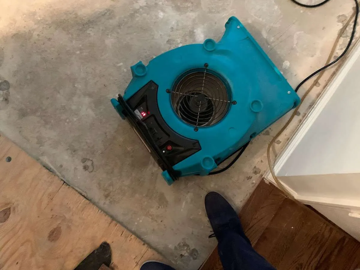 Air mover drying subfloor during Commercial Water Damage Restoration in Willow Springs